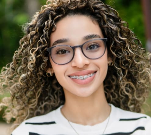 girl with braces and glasses smiling