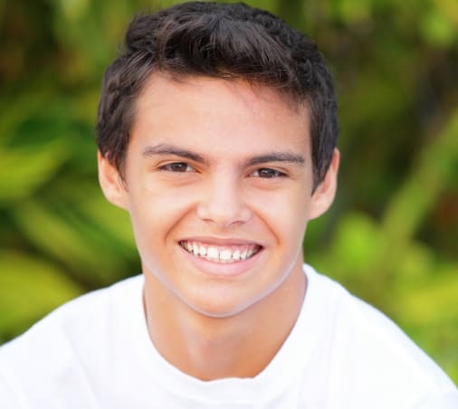 boy with white shirt smiling